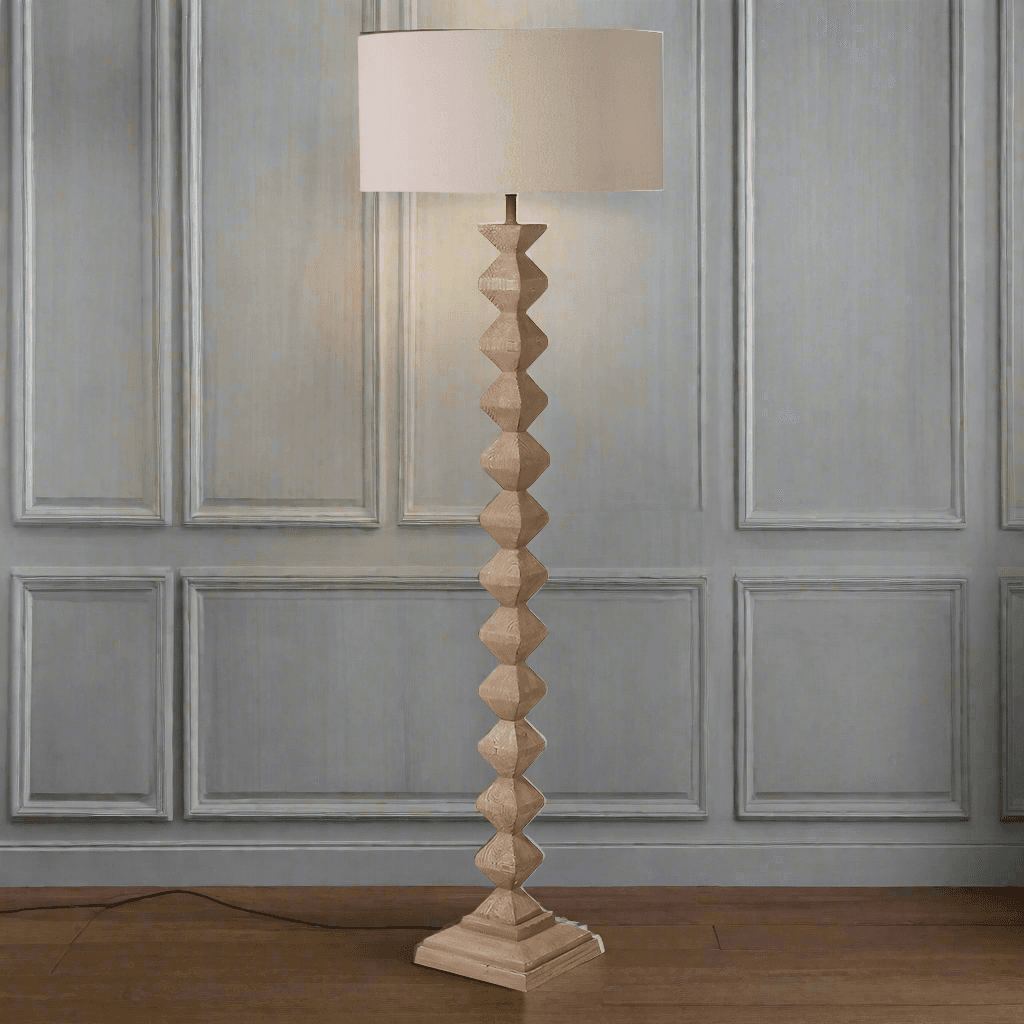 A really interesting notched, carved wooden floor lamp base, perfectly matched with a round linen shade of similar colour. Perfect neutral colour to blend in any interior. 
