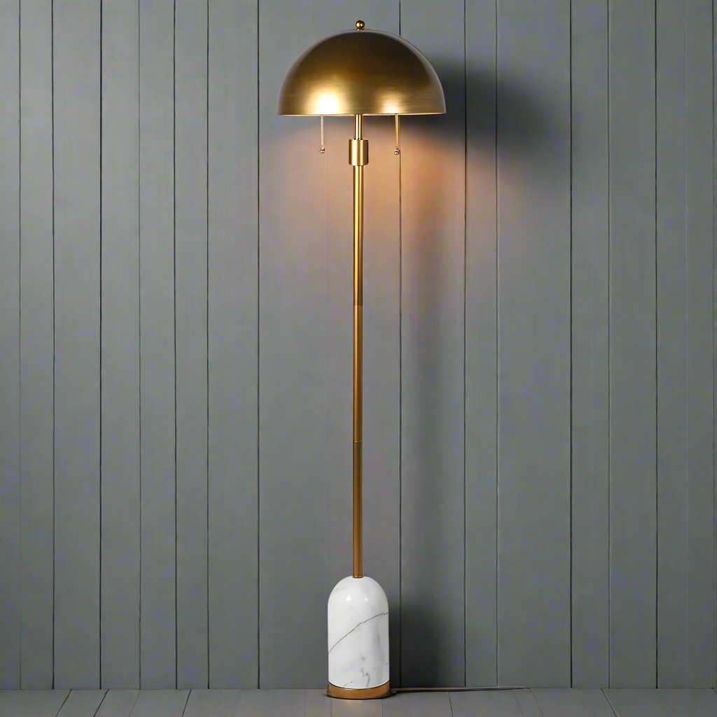 Gilt metal floor lamp on a white marble base, the shade is also gilt metal in a dome shape, an exceptional design led look.