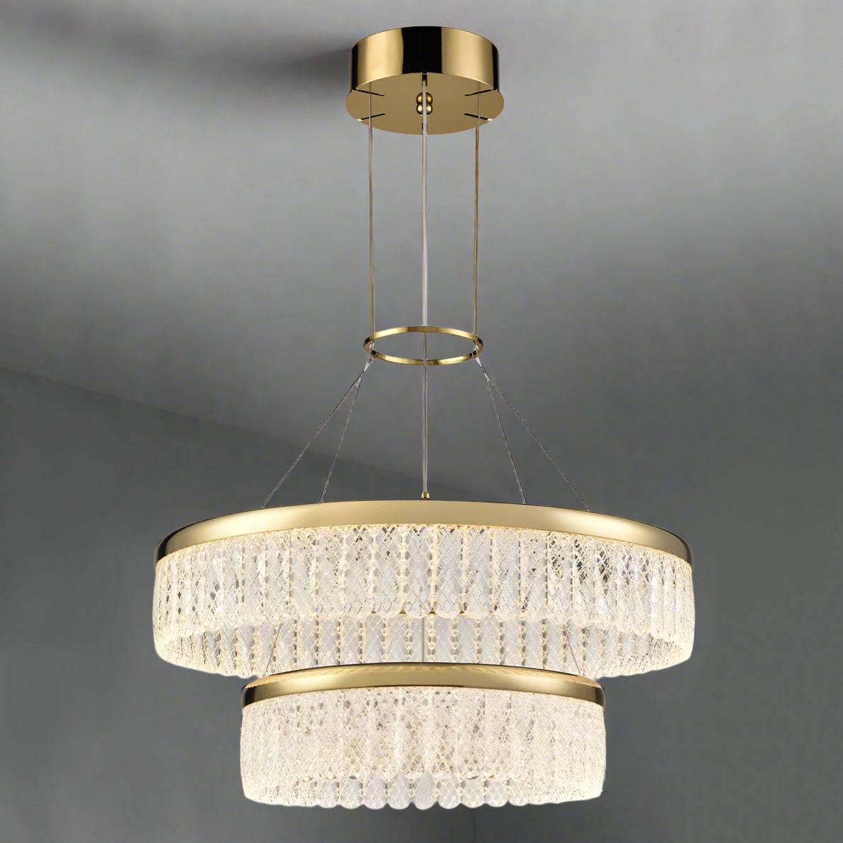 Exceptionally pretty double gilt and crystal chandelier. The fixture consists of intricate, delicate, lattice crystal drops on a two round gilt metal circular bands gathered at the top with a gilt 