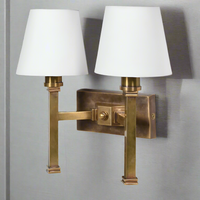 Double rubbed antique brass wall light with two fabric shades. The sturdy wall light is perfect for a living room or a bedroom.&nbsp;&nbsp; You get the added bonus of twice the amount of light, in a dark hallway or landing. The addition of two fabric shades allows the light to stream out.