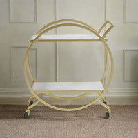 Art deco style drinks trolley, in a typical gilt metal but with the addition of super luxurious white marble shelves.&nbsp; The cirular gilt metal frame is set on castors, perfect for ease of movement when offering your guests drinks.