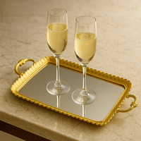 gilt tray with mirrored top and two decorative handles, great in a bedroom for jewellery or as a festive serving tray.