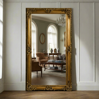 Extra  large classic ornate gold mirror  In a hallway, leant against a  wall in a traditional living room