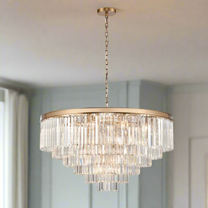 This six-tier crystal chandelier is designed to make a bold, unforgettable statement in any room. Its polished gold band supports cascading layers of prism-cut crystals