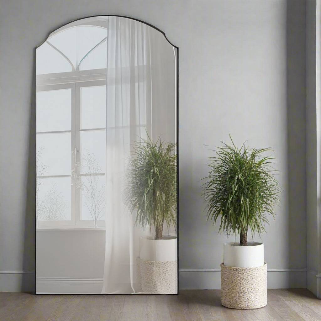 A simple and highly effective mirror minimalist in design yet maximum in impact.&nbsp; With an arched top and a slim black frame that is 2cm in depth, the striking thing about this mirror is the sheer volume of glass that reflects and bounces light back into your room. The subtle curves add a touch of sophistication.