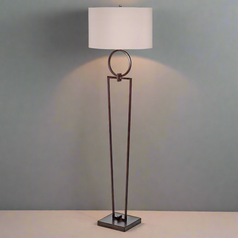 Tall bronze metal floor lamp, with a metal circle decoration to the top, with a round natural fabric shade.&nbsp; A classic living room floor light, striking and elegant.