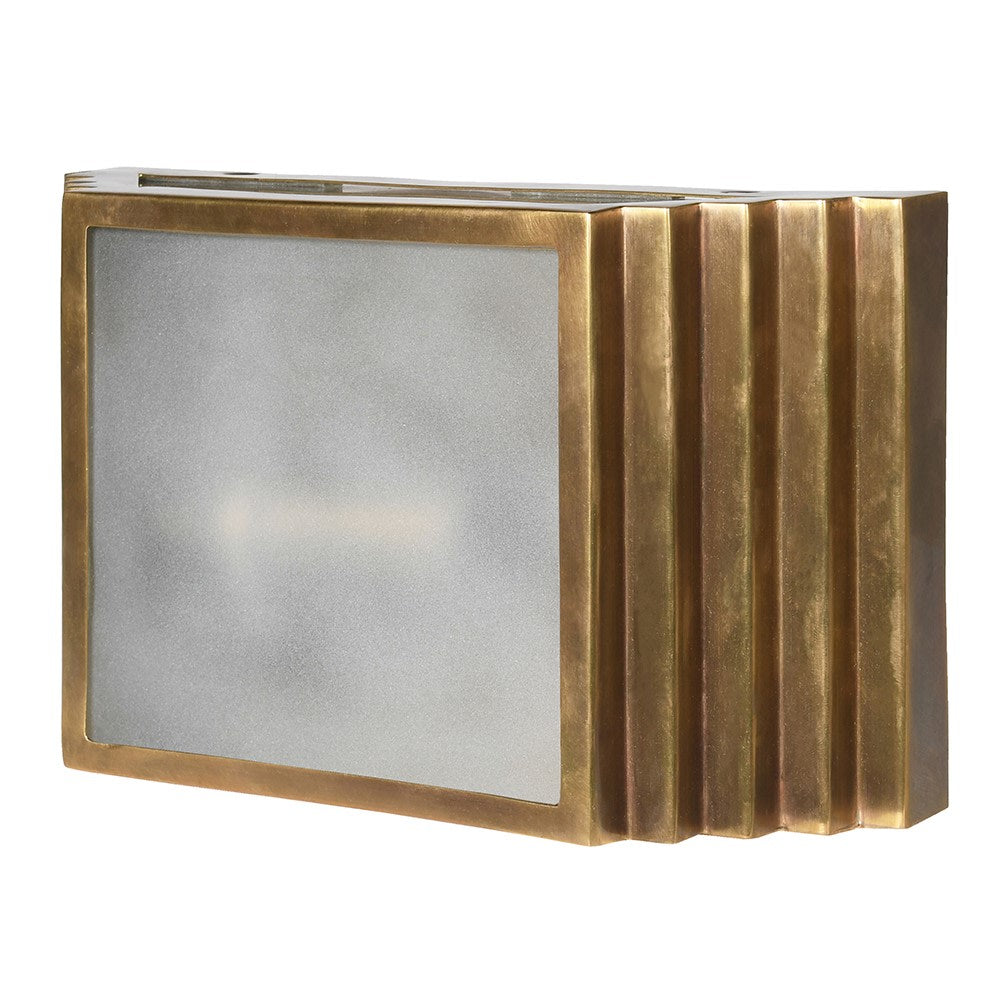 A brass wall light in the shape of a stepped brushed brass box, with a frosted front.&nbsp; The overall effect of this stunning wall light is of the 'art deco' period, the box construction with the frosted glass detail to the front.&nbsp; The lamp can be hung vertically or horizontally and will exude a beautiful muted light. Two of these on your wall will create a dramatic, stylish effect.