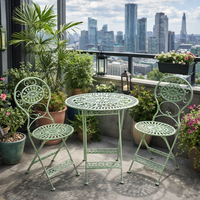 Green iron garden furniture table and two chairs, fully folding for easy winter storage. The set is the perfect size for a smaller garden and perfect for a patio or balcony