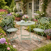 Green iron garden furniture table and two chairs, fully folding for easy winter storage. The set is the perfect size for a smaller garden and perfect for a patio or balcony