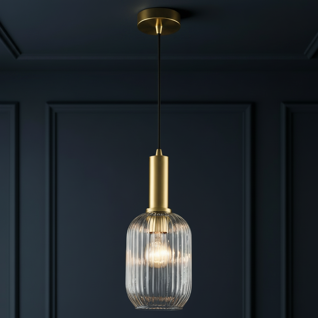 Clear, ribbed glass pendant with tall gilt metal fitting, a statement look in a smaller size. The stylish metalwork on this ribbed glass pendant lifts it to another level of style.