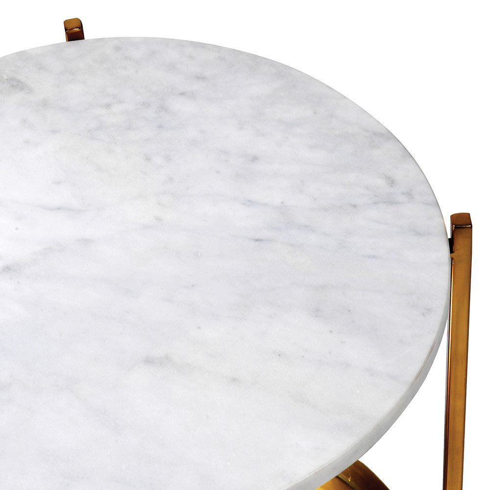 Close-up of a white marble top on a two-tier side table with a gilt metal frame, showcasing luxurious design and smooth finish.