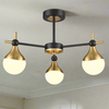 A three brushed gold and opaque glass globe light.&nbsp; Semi-flush on a back and gold metal fixture creating stunning mix of colours for both contemporary and classic settings. This stylish semi-flush pendant would look amazing in a bedroom, hall over a dining table. The mixture of colours is perfect.
