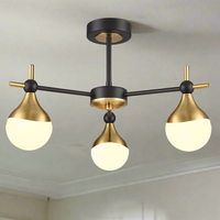 A three brushed gold and opaque glass globe light.&nbsp; Semi-flush on a back and gold metal fixture creating stunning mix of colours for both contemporary and classic settings. This stylish semi-flush pendant would look amazing in a bedroom, hall over a dining table. The mixture of colours is perfect.