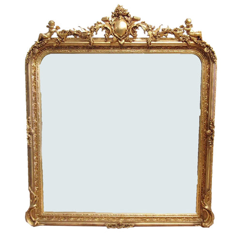 Tall, very ornate giltwood mirror, in a period style with ornate beaded edge. Crested with ornate flourishes to the top - exceptionally decorative overmantle shaped mirror.