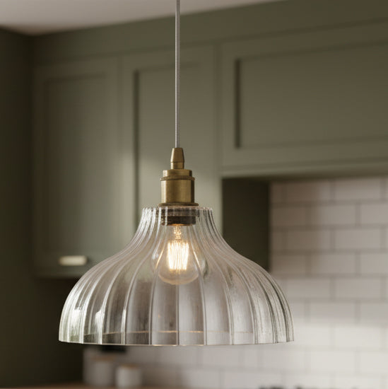 Ribbed glass and brass metalwork pendant light.
Unusual ribbed light, disperses light softly in your space, ideal hall light or in a kitchen, over an island, a versatile light to suit any decor.