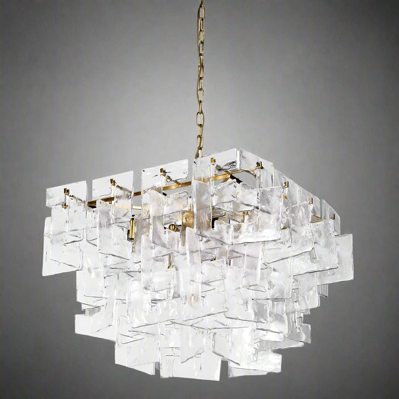A statement chandelier made up of textured glass links resembling thick frosted crystal.&nbsp; &nbsp;The links are laid out in an overlapping layers, supported on a meal frame of antique gold providing a warm contrast to the cool, clear glass.&nbsp; Suspended on a chunky chain from a metal ceiling rose, the chandelier requires E14 bulb to give the radiant, ambient glow.&nbsp; Ideal for a foyer, living room or dining room .

H:&nbsp; 50 cm W: 75 cm&nbsp; D 75 cm&nbsp;