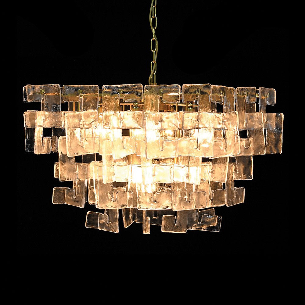 A statement chandelier made up of textured glass links resembling thick frosted crystal.&nbsp; &nbsp;The links are laid out in an overlapping layers, supported on a meal frame of antique gold providing a warm contrast to the cool, clear glass.&nbsp; Suspended on a chunky chain from a metal ceiling rose, the chandelier requires E14 bulb to give the radiant, ambient glow.&nbsp; Ideal for a foyer, living room or dining room .

H:&nbsp; 50 cm W: 75 cm&nbsp; D 75 cm&nbsp;