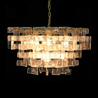 A statement chandelier made up of textured glass links resembling thick frosted crystal.&nbsp; &nbsp;The links are laid out in an overlapping layers, supported on a meal frame of antique gold providing a warm contrast to the cool, clear glass.&nbsp; Suspended on a chunky chain from a metal ceiling rose, the chandelier requires E14 bulb to give the radiant, ambient glow.&nbsp; Ideal for a foyer, living room or dining room .

H:&nbsp; 50 cm W: 75 cm&nbsp; D 75 cm&nbsp;