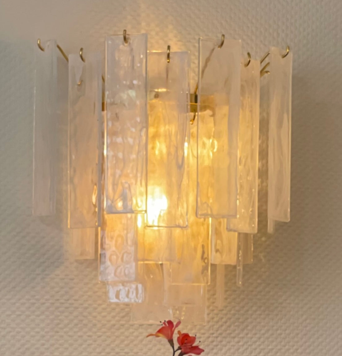 Stunningly glamorous wall light of wavy white glass prisms on gold metal.&nbsp; An interestingly large wall light which makes a feature wall.   H: 35 cm W: 35 cm D: 19 cm&nbsp;  Weight: 5.7 Kg