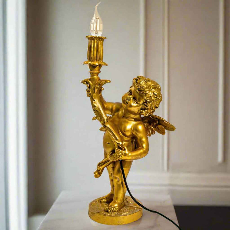 Gold cherub table light, perfectly formed cherubim hand outstretched holding a lamp.