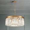 Gold metal rimmed crystal prism chandelier.&nbsp; Very high quality crystal prism drops suspended from a brushed gold finish metal surround.&nbsp; This medium size crystal light is perfect over a dining table or as the main light in your sitting room - exceptional.