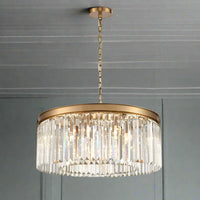 Gold metal rimmed crystal prism chandelier.&nbsp; Very high quality crystal prism drops suspended from a brushed gold finish metal surround.&nbsp; This medium size crystal light is perfect over a dining table or as the main light in your sitting room - exceptional.