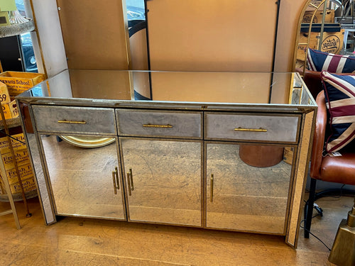 Aged glass sideboard with gilt trim and velvet covered drawers. W: 140 cm D: 54 cm H: 80 cm. Perfect living room sideboard or as a hall table with storage for a statement entrance.