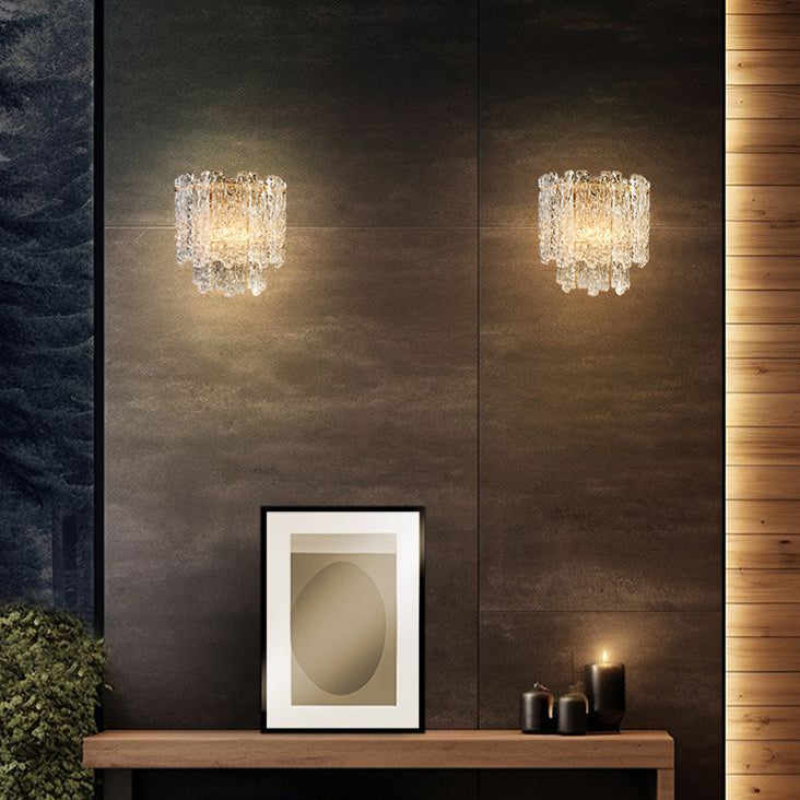 Icicle shard wall light with textured glass panels  and aged brushed brass metal fittings in a luxury room