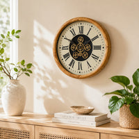 This large industrial wall clock combines a warm wood-effect frame with a cream clock face, bold black Roman numerals and an exposed gear-style centre.