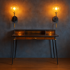 Clear globe wall light set on a circular matte black finish back plate, a long vertical rod extends from the base with a brushed brass cylindrical accent making for a an elegant contrast. Near the top of the rod is a brass socket for the bulb.

The clean lines and black gold combination on this long clear globe wall light evokes a sophisticated aesthetic.&nbsp;&nbsp;

H: 45 cm W: 20 cm D: 25 cm&nbsp;