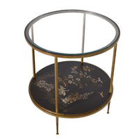 Angled view of the two-tier side table with a glass top and lacquered lower shelf, highlighting the decorative Japanese-inspired design and gold-tone frame.