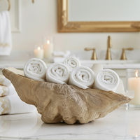 Large decorative shell bowl used for bathroom towel storage