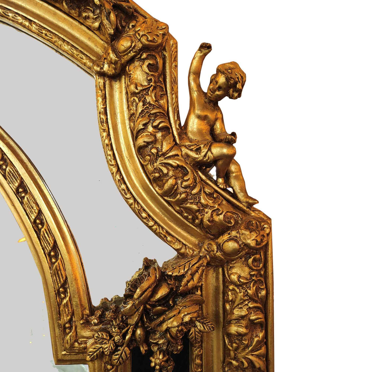Giltwood arched mirror with cherub accents