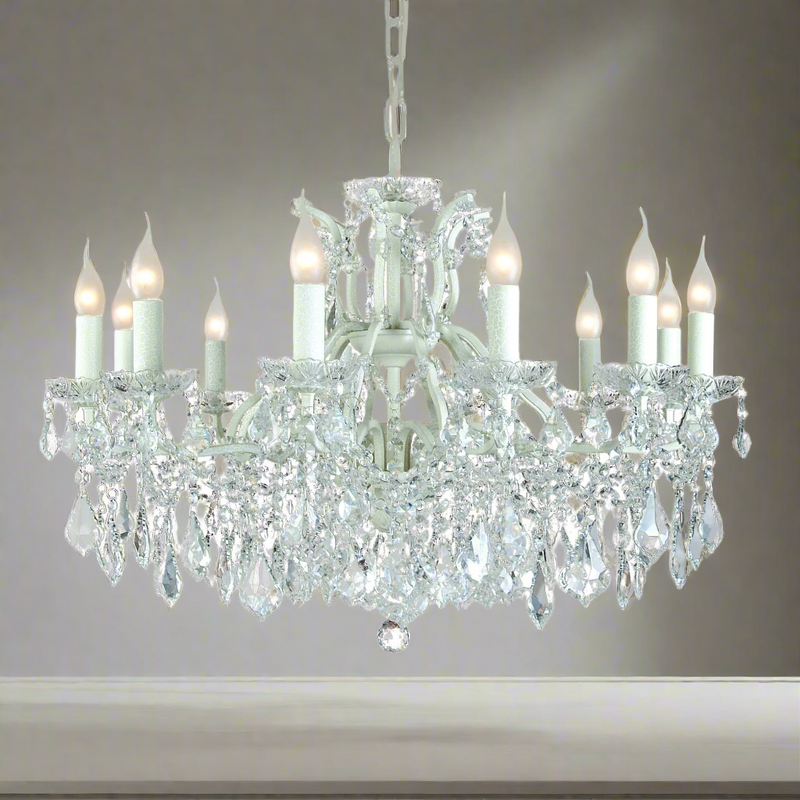 Large, 12 arm classic white metal chandelier, smothered in crystal drops a classic look for a contemporary room, adding a mass of light from the twelve bulbs. Perfect period home lighting.