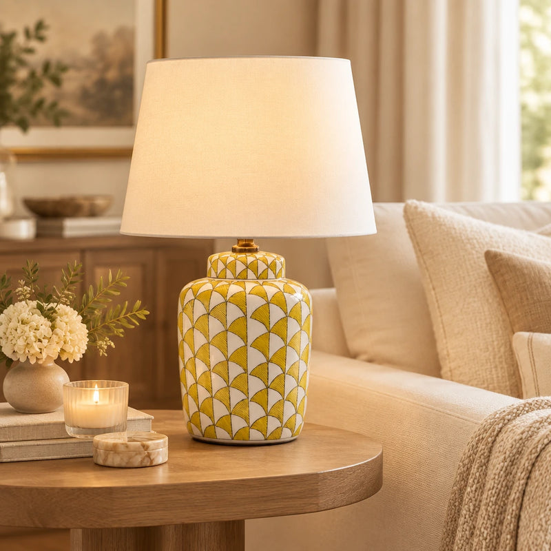 Lemon and white coloured, urn shaped ceramic lamp with a bright white fabric shade. 