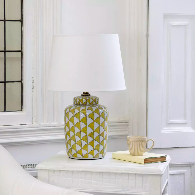 Lemon and white coloured, urn shaped ceramic lamp with a bright white fabric shade. Will brighten any room you place it in, a touch of summer, even in the darkest seasons.&nbsp; The diagonal lemon pattern on a white background has a great contemporary feel, perfect in a modern home and the ceramic finish is a classic for a period home.&nbsp; An ideal lamp for creating a cosy atmosphere combining functionality with a chic design.&nbsp;
