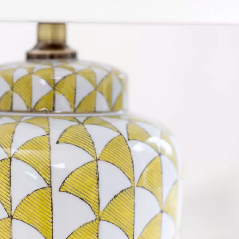Lemon and white coloured, urn shaped ceramic lamp with a bright white fabric shade. Will brighten any room you place it in, a touch of summer, even in the darkest seasons.&nbsp; The diagonal lemon pattern on a white background has a great contemporary feel, perfect in a modern home and the ceramic finish is a classic for a period home.&nbsp; An ideal lamp for creating a cosy atmosphere combining functionality with a chic design.&nbsp;