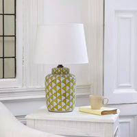 Lemon and white coloured, urn shaped ceramic lamp with a bright white fabric shade. Will brighten any room you place it in, a touch of summer, even in the darkest seasons.&nbsp; The diagonal lemon pattern on a white background has a great contemporary feel, perfect in a modern home and the ceramic finish is a classic for a period home.&nbsp; An ideal lamp for creating a cosy atmosphere combining functionality with a chic design.&nbsp;
