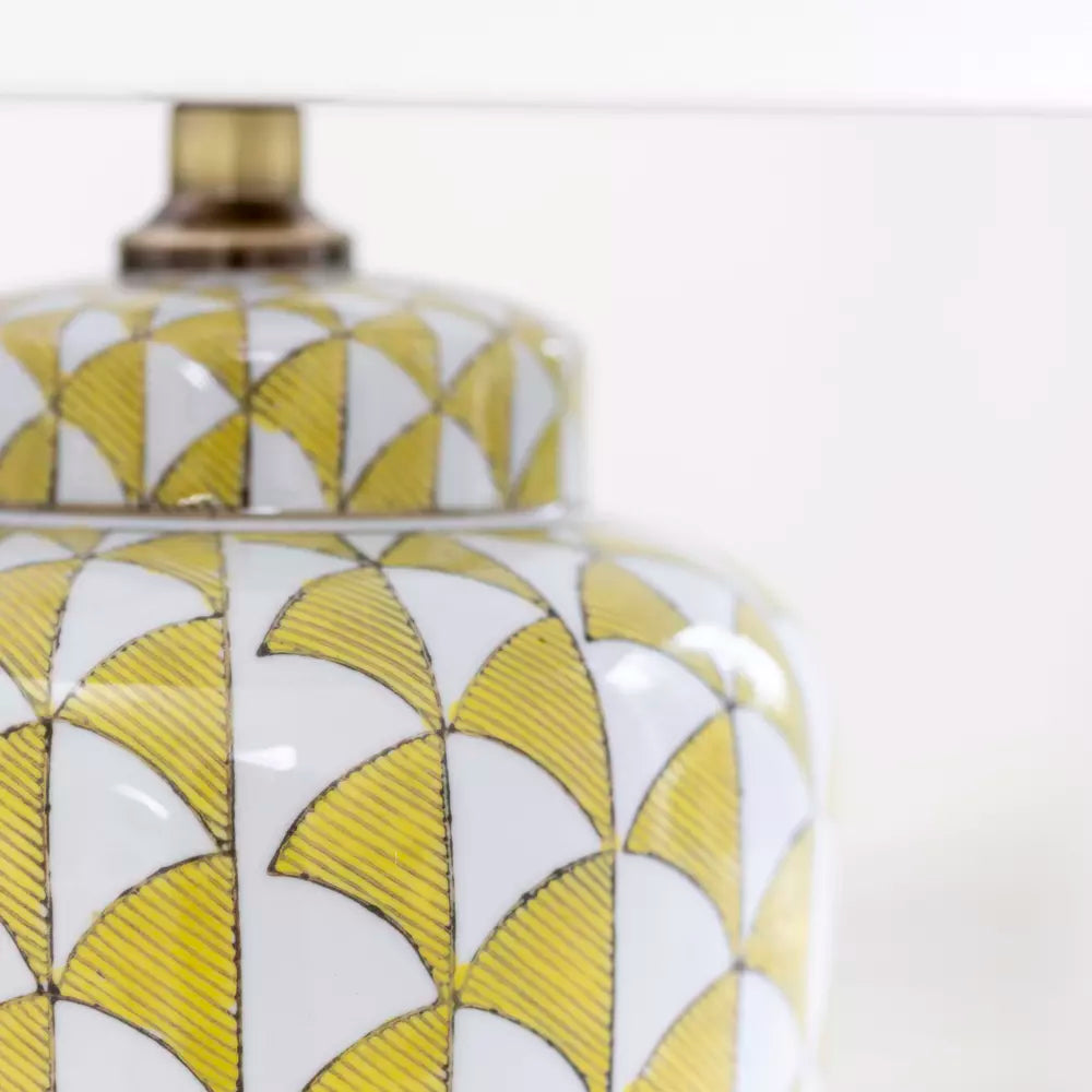 Lemon and white coloured, urn shaped ceramic lamp with a bright white fabric shade. Will brighten any room you place it in, a touch of summer, even in the darkest seasons.&nbsp; The diagonal lemon pattern on a white background has a great contemporary feel, perfect in a modern home and the ceramic finish is a classic for a period home.&nbsp; An ideal lamp for creating a cosy atmosphere combining functionality with a chic design.&nbsp;
