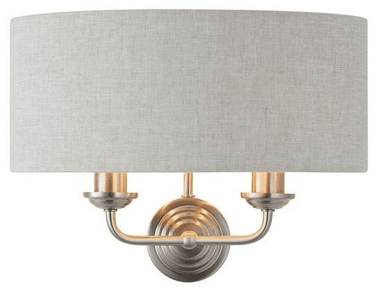 A natural linen half moon shade wall light with twin brushed chrome arms. This light emits a soft warm light perfect for a living, hallway, or bedroom space.