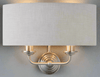 A natural linen half moon shade wall light with twin brushed chrome arms. This light emits a soft warm light perfect for a living, hallway, or bedroom space.
