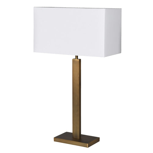 A luxurious looking tall gilt metal lamp with rectangular white shade with a gold lining adding to the overall warm gold glow of the entire piece. A total stylish statement lamp.