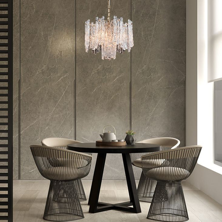 Icicle shard chandelier with textured glass panels at varying heights to refract the lights. It has 5 lights and aged brushed brass metal fittings. Perfect sitting room chandelier, a glamorous, statement light.