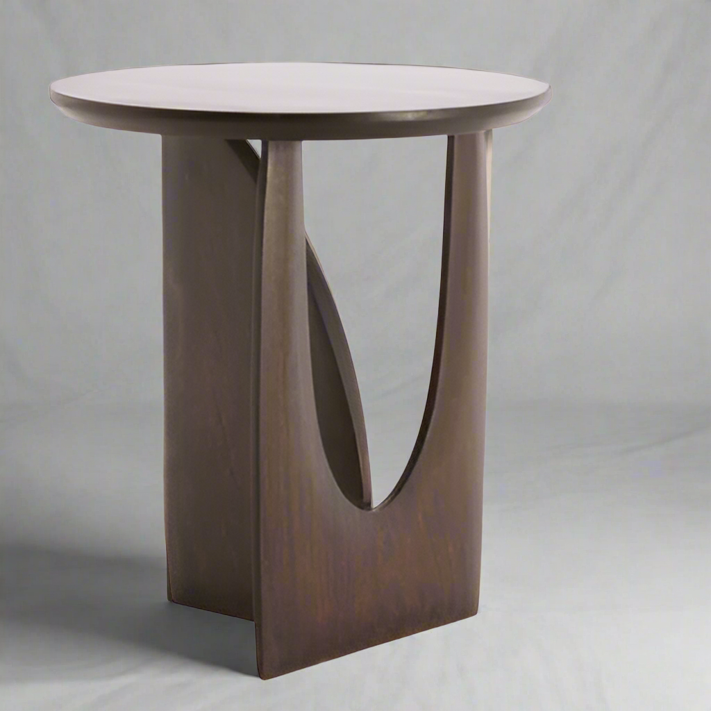 A contemporary side table in mango wood.&nbsp; A dark chocolate coloured table in a sculptural design.&nbsp; A beautiful, stylish modern side table which would work well in a mid-century or industrial interior.&nbsp; The solid mango finish is sturdy and hard wearing. A stylish classic.&nbsp;