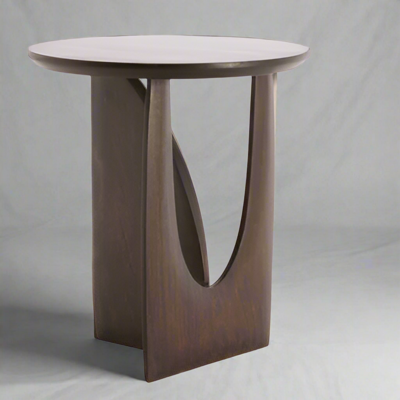 A contemporary side table in mango wood.&nbsp; A dark chocolate coloured table in a sculptural design.&nbsp; A beautiful, stylish modern side table which would work well in a mid-century or industrial interior.&nbsp; The solid mango finish is sturdy and hard wearing. A stylish classic.&nbsp;