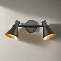 Matt black double wall light with gold inner.&nbsp; Simple black metal rose with two black metal shades on a bar, directional lighting at it's industrial best. Great kitchen wall lighting, or perfect in a study or dining room.


H: 15 cm W:&nbsp; 30 cm