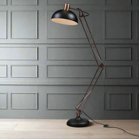 Vintage arc style floor lamp in copper metal with a black metal shade and base.&nbsp; Perfect way to add light to a room, the open shade throwing light in the direction you require.