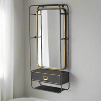 Metal swivel mirror set in dark metal casing with drawer, accented in brushed brass colour. Useful wall mounted mirror with the addition of a small drawer, perfect for your hall or bedroom.&nbsp;