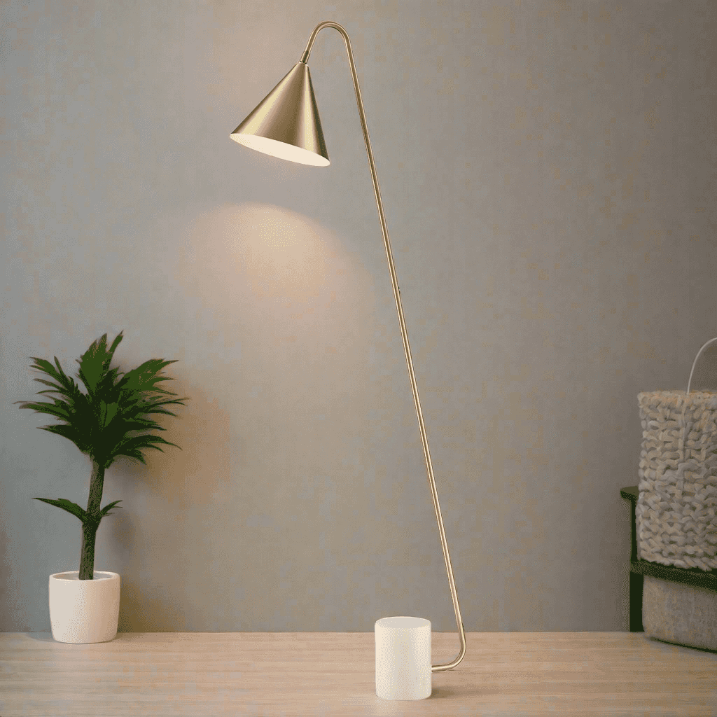 Stunning, stylish gilt metal floor lamp on a white marble base. The shade is satin brass with a white inner.&nbsp;&nbsp; A minimalist lamp perfect for a contemporary interior.&nbsp; The lamp is offset at an angle on a white marble plinth.&nbsp;