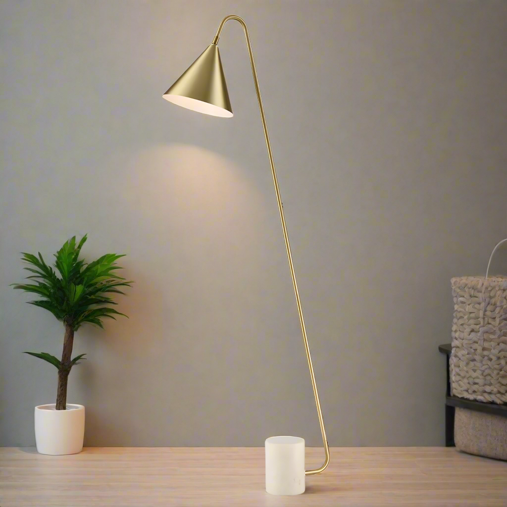 Stunning, stylish gilt metal floor lamp on a white marble base. The shade is satin brass with a white inner.&nbsp;&nbsp; A minimalist lamp perfect for a contemporary interior.&nbsp; The lamp is offset at an angle on a white marble plinth.&nbsp;
